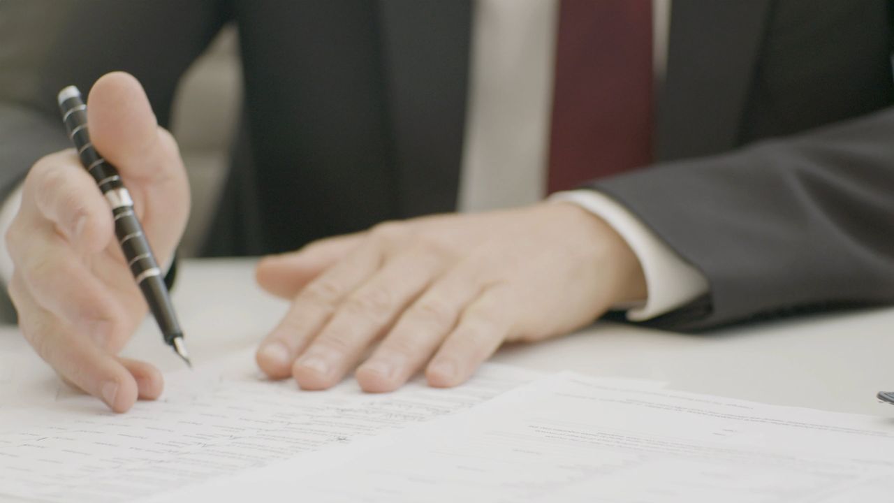 Business people reviewing filing documents together at a table